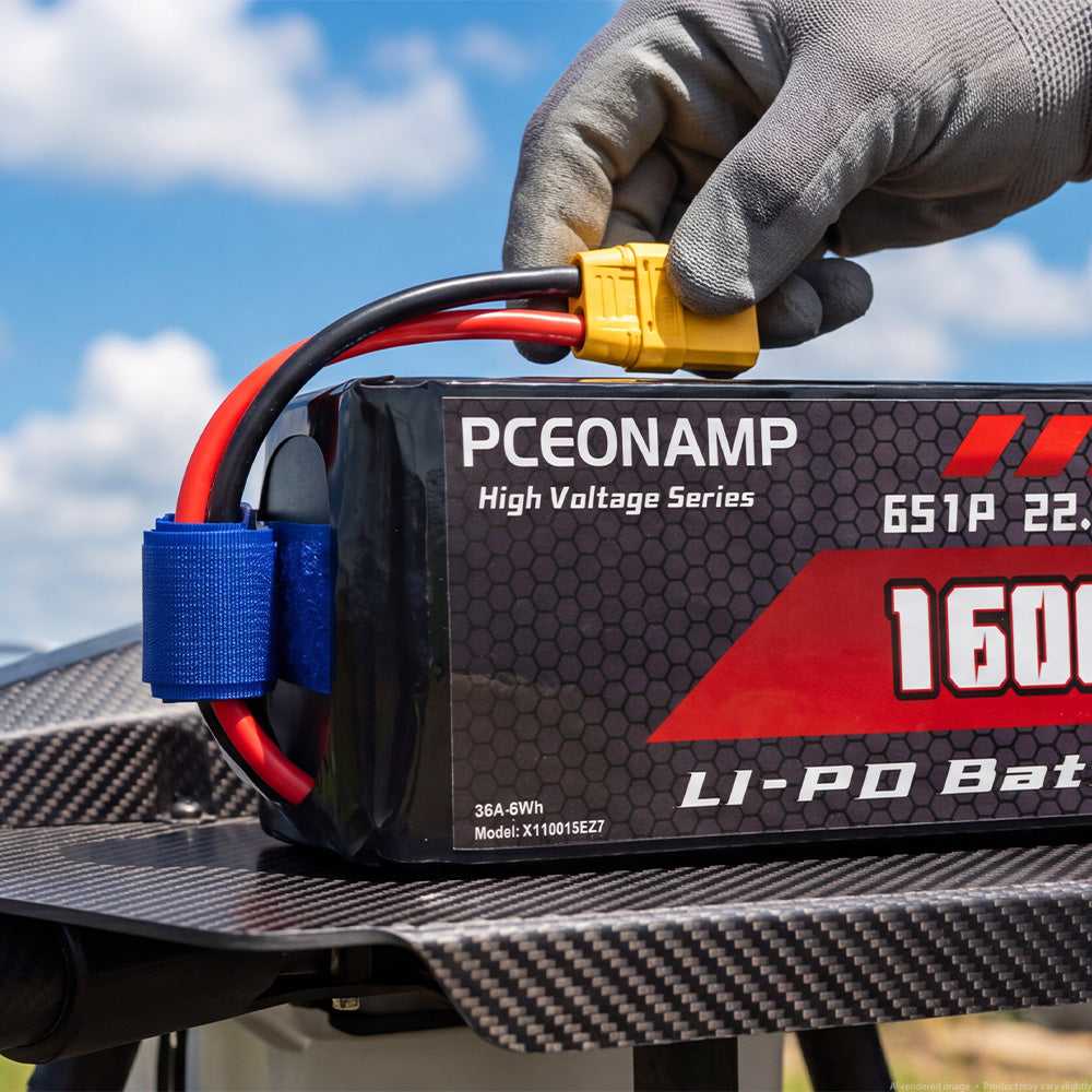 Gloved hands connecting XT90S plug on PCEONAMP 6S HV LiPo battery