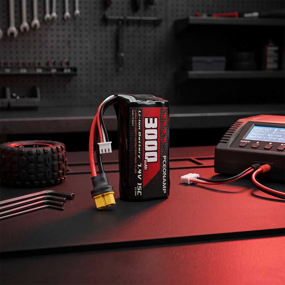 PCEONAMP 7.4V 3000mAh 2S Li-ion battery with XT60 plug on a red workbench, next to an RC tire, hex wrenches, and a digital battery charger.